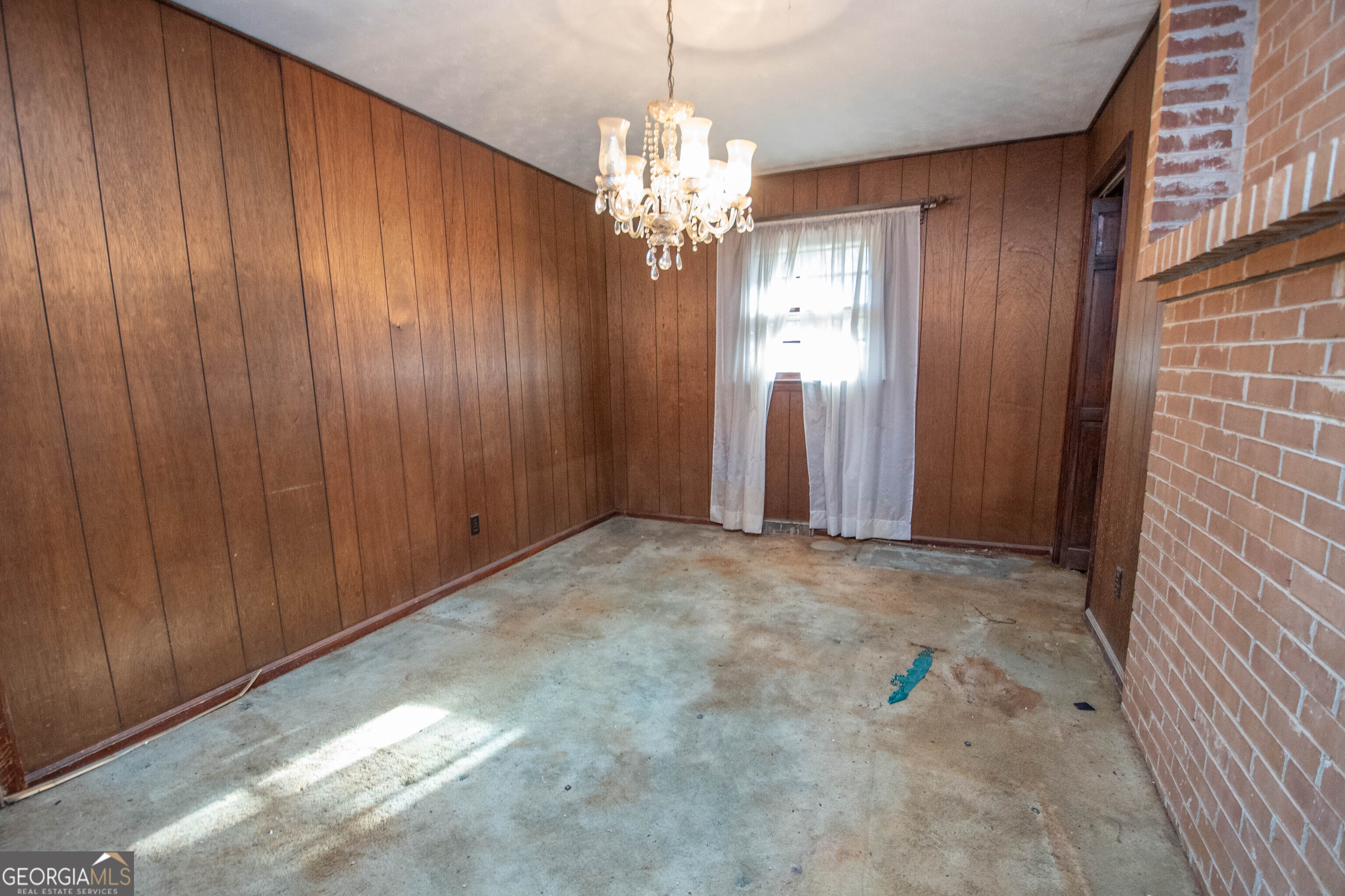 980 Grandma Branch Road Grantville, GA 30220 - Photo 8 of 33 a view of an empty room with window and chandelier