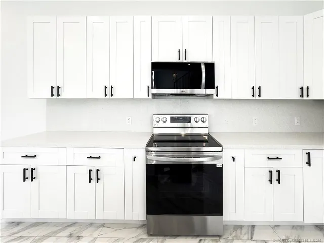 a kitchen with a stove and a microwave
