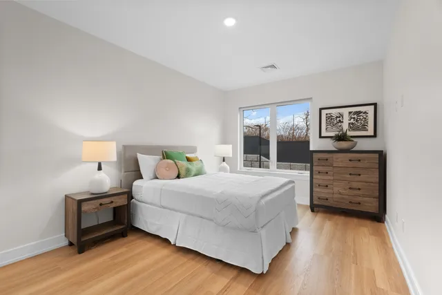 a bedroom with a bed and a dresser