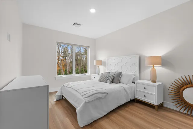 a bedroom with a bed and a window