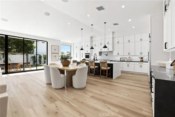 a kitchen with stainless steel appliances granite countertop a sink a stove and a refrigerator