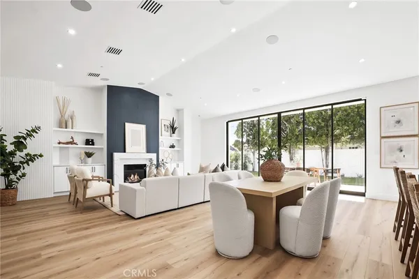 a living room with fireplace furniture and a large window