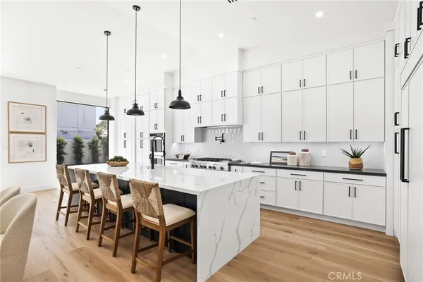 a kitchen with stainless steel appliances a stove a sink and a refrigerator