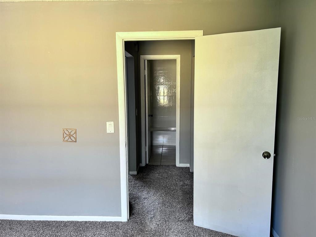 1625 West Oak Ridge Road, Unit C Orlando, FL 32809 - Photo 11 of 11 a view of a bathroom with a glass door