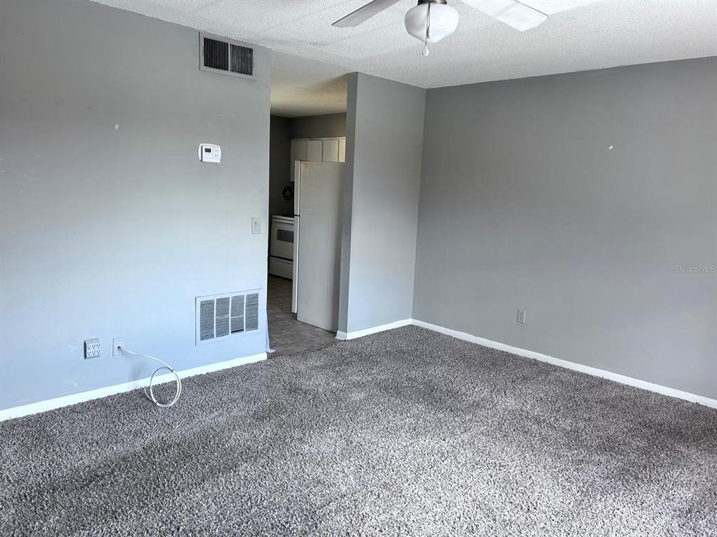 1625 West Oak Ridge Road, Unit C Orlando, FL 32809 - Photo 5 of 11 a view of an empty room with a window
