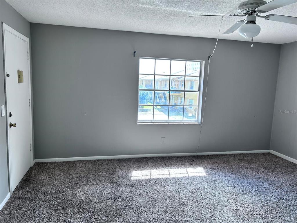 1625 West Oak Ridge Road, Unit C Orlando, FL 32809 - Photo 7 of 11 an empty room with a window