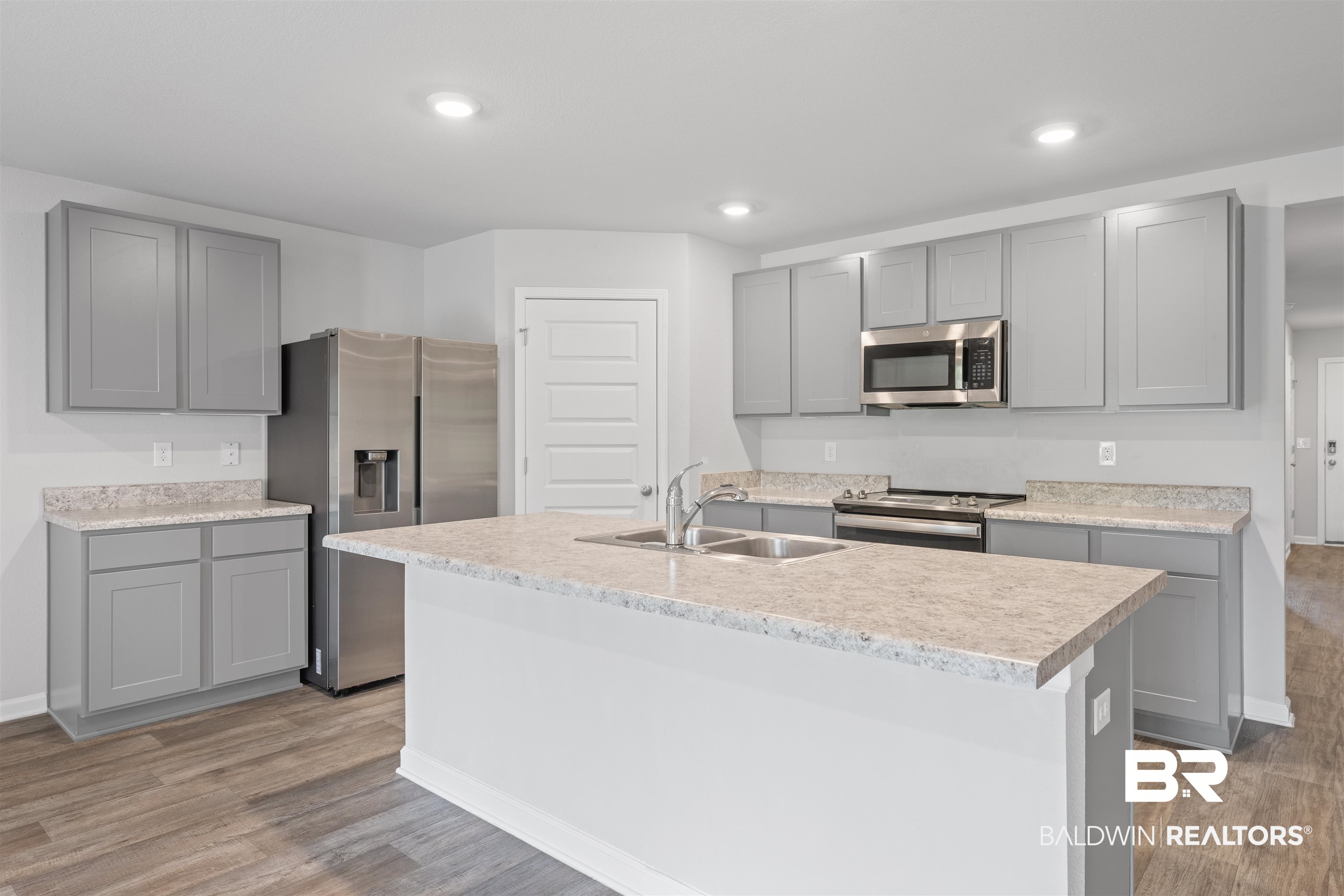 7457 Brompton Drive Foley, AL 36535 - Photo 4 of 24 Kitchen with gray cabinets, stainless steel appliances, light wood-type flooring, an island with sink, and recessed lighting
