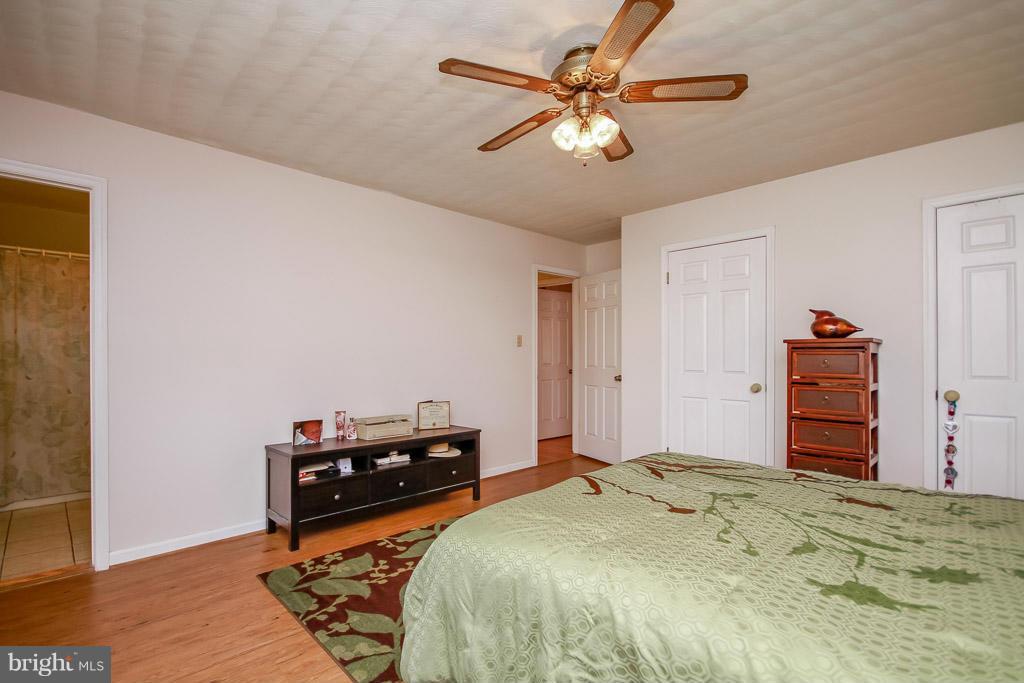 2667 Sandymount Road Finksburg, MD 21048 - Photo 22 of 30 a bedroom with a bed and a chandelier
