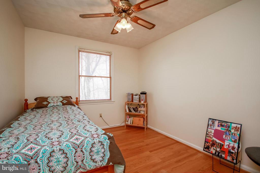 2667 Sandymount Road Finksburg, MD 21048 - Photo 24 of 30 a bedroom with a bed and a chandelier