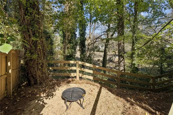 a backyard of a house with table and chairs