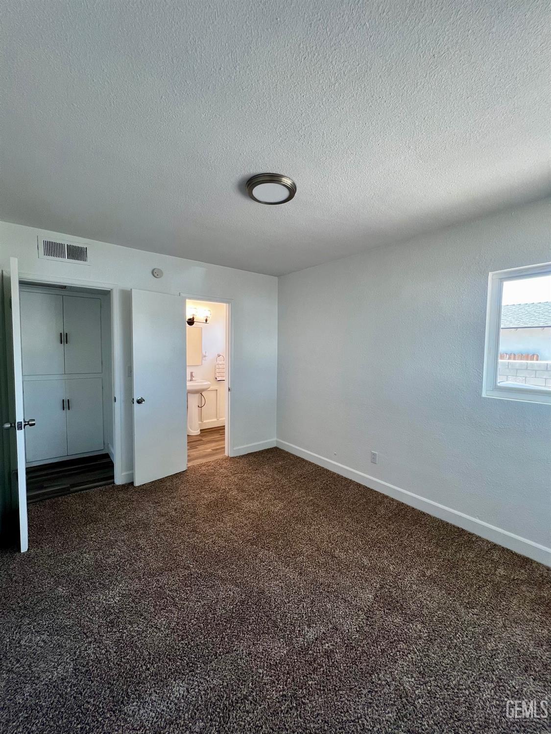Undisclosed Address Bakersfield, CA 93304 - Photo 16 of 20 an empty room with closet and windows