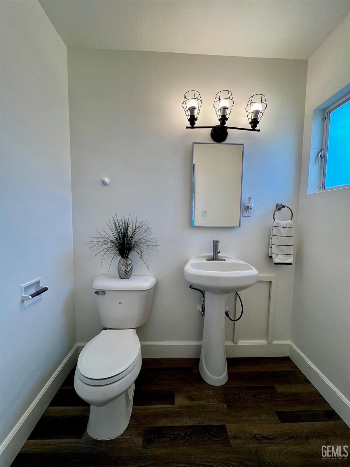 Undisclosed Address Bakersfield, CA 93304 - Photo 17 of 20 a bathroom with a toilet sink and mirror