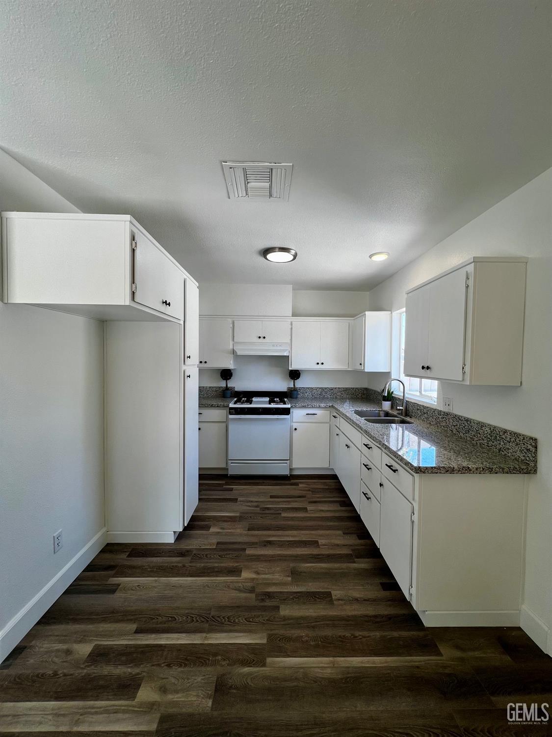 Undisclosed Address Bakersfield, CA 93304 - Photo 9 of 20 a large kitchen with cabinets and stainless steel appliances