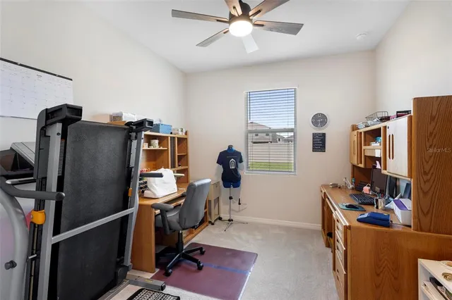 a view of a workspace with furniture and a window