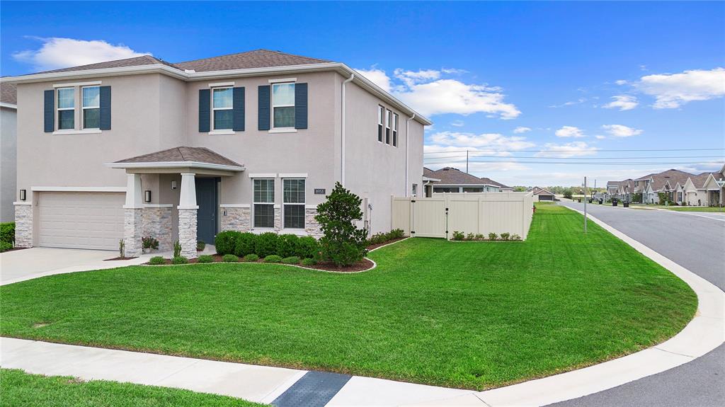 8953 Southwest 50th Terrace Ocala, FL 34476 - Photo 3 of 49 a front view of a house with a garden and yard
