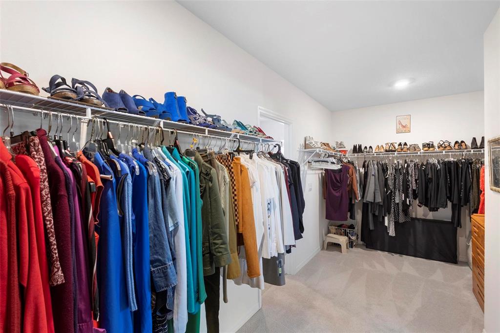 8953 Southwest 50th Terrace Ocala, FL 34476 - Photo 36 of 49 a view of walk in closet with clothes and shoes