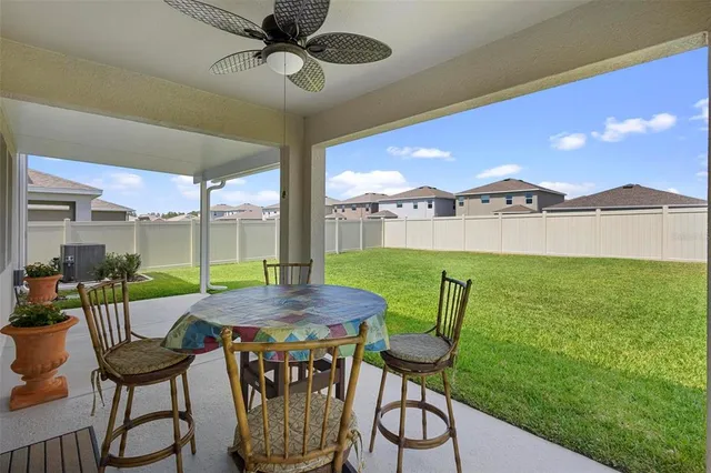 a view of an outdoor dining space with furniture and garden