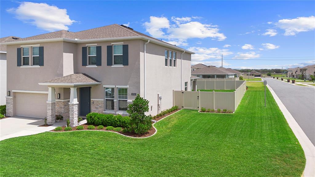 8953 Southwest 50th Terrace Ocala, FL 34476 - Photo 4 of 49 a front view of a house with a yard
