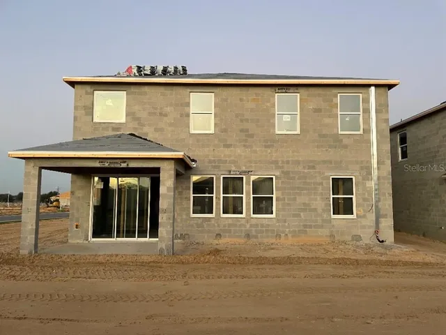 a front view of a house with large windows