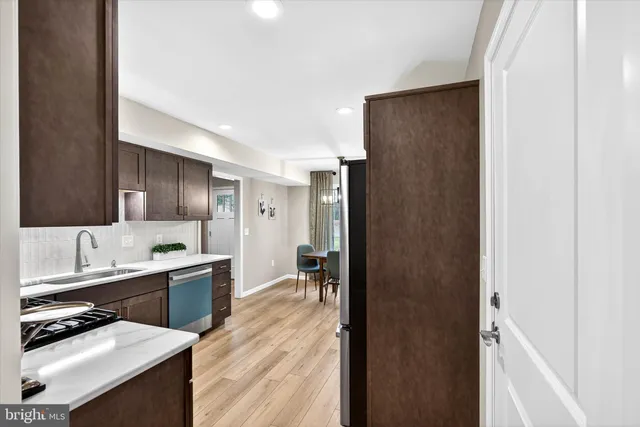 a kitchen with a refrigerator and a sink