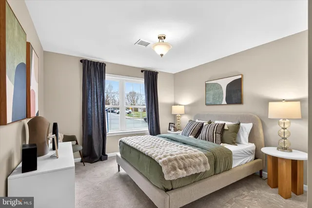 a bedroom with a bed and a lamp