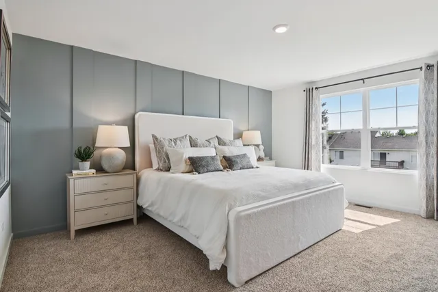a bedroom with a bed and a potted plant