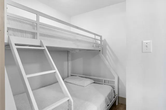 a bathroom with a toilet a sink a tub and mirror