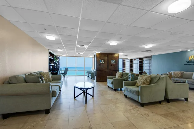 a living room with furniture and a ceiling fan