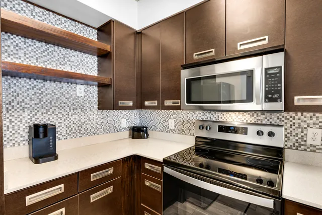a kitchen with stainless steel appliances a stove and a microwave