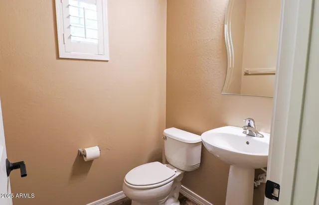 a white toilet sitting next to a bathroom sink