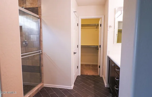 an empty room with a bathroom and a sink