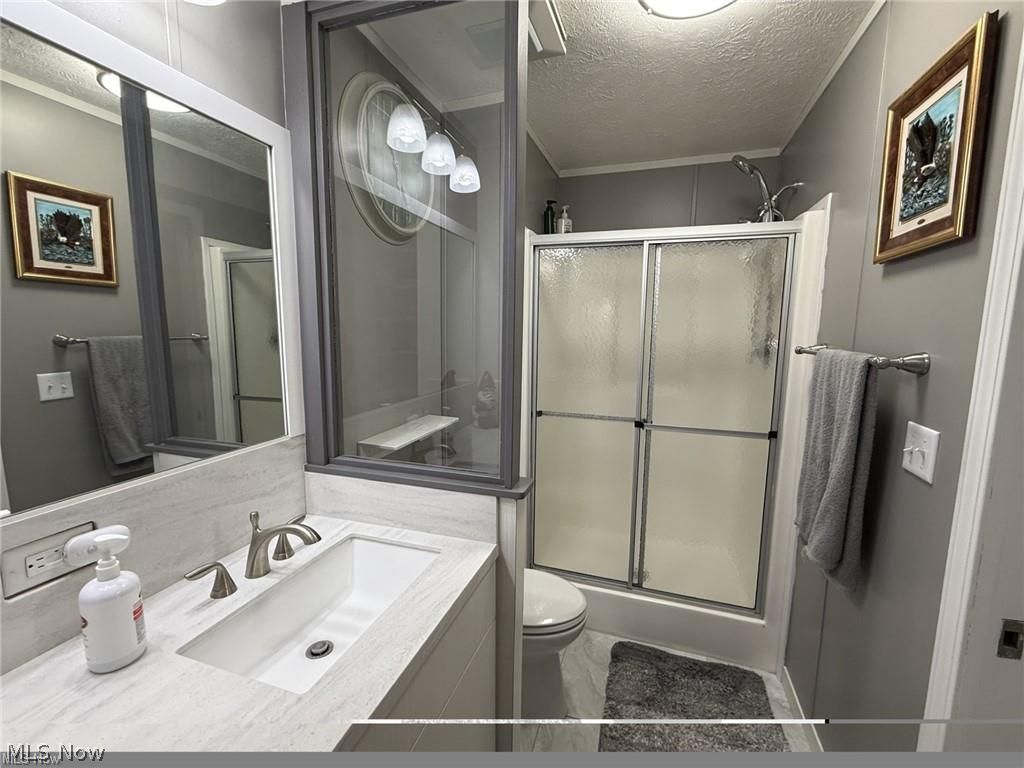 10252 Wellman Road, Unit 19 Streetsboro, OH 44241 - Photo 8 of 12 Completely remodeled primary bathroom with newer vanity, Corian countertops, newer light fixtures, walk-in shower