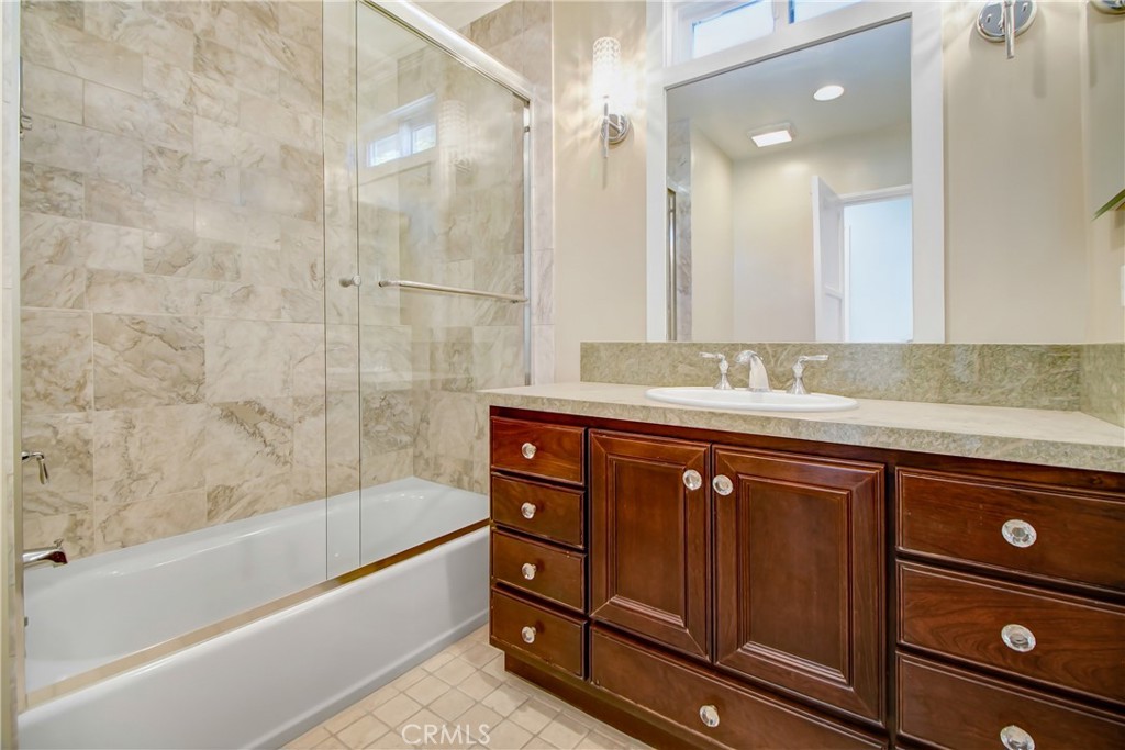 6632 Belmar Avenue Reseda, CA 91335 - Photo 3 of 10 a bathroom with a granite countertop bathtub sink vanity and mirror