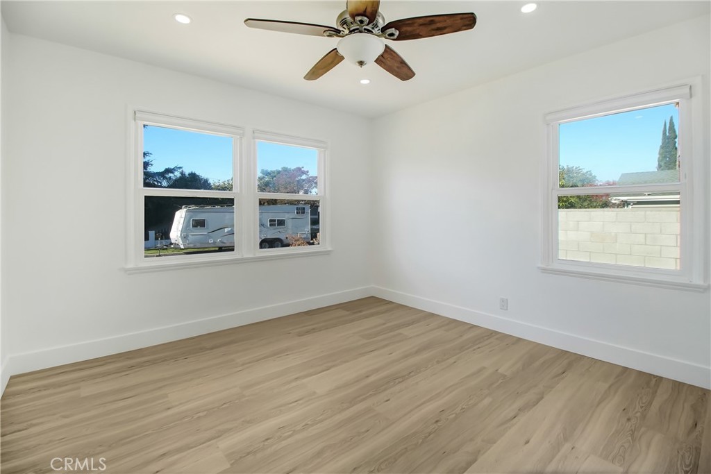6632 Belmar Avenue Reseda, CA 91335 - Photo 5 of 10 a view of an empty room with a window and wooden floor