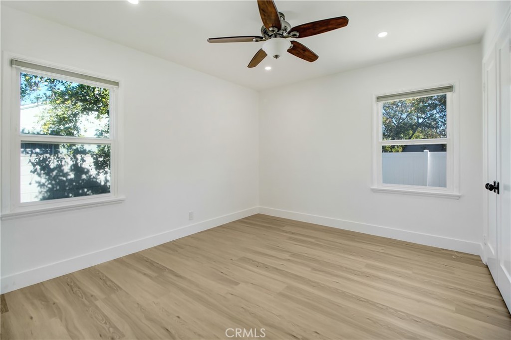 6632 Belmar Avenue Reseda, CA 91335 - Photo 6 of 10 a view of empty room with wooden floor and fan