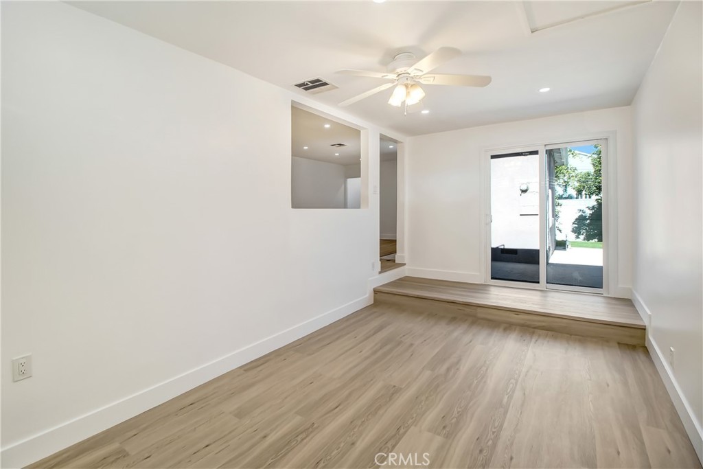 6632 Belmar Avenue Reseda, CA 91335 - Photo 7 of 10 an empty room with wooden floor and windows