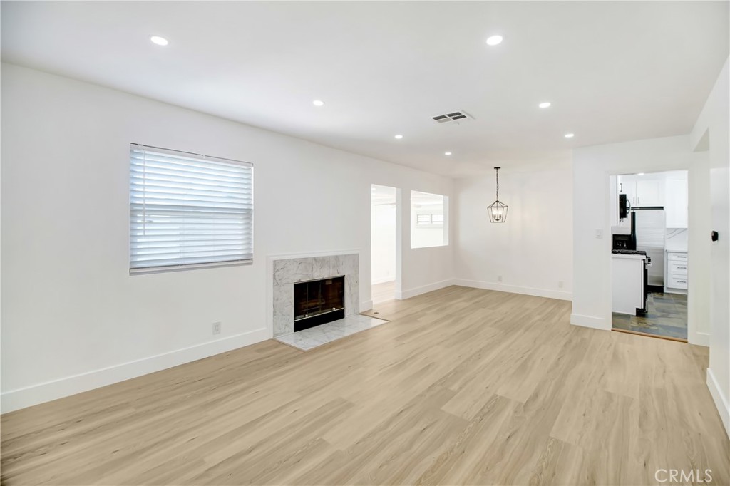 6632 Belmar Avenue Reseda, CA 91335 - Photo 10 of 10 a view of empty room with wooden floor and fireplace