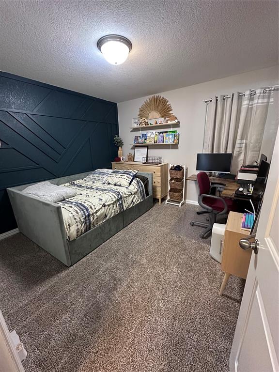 1212 Bowman Ridge Road Stephenville, TX 76401 - Photo 11 of 23 a bedroom with furniture and a wooden floor