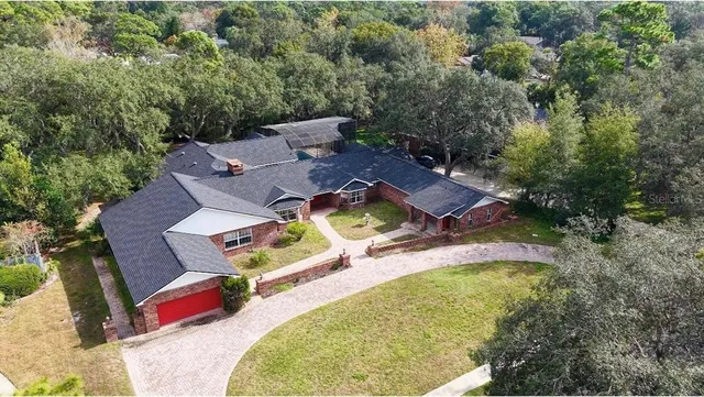 an aerial view of a swimming pool with outdoor seating