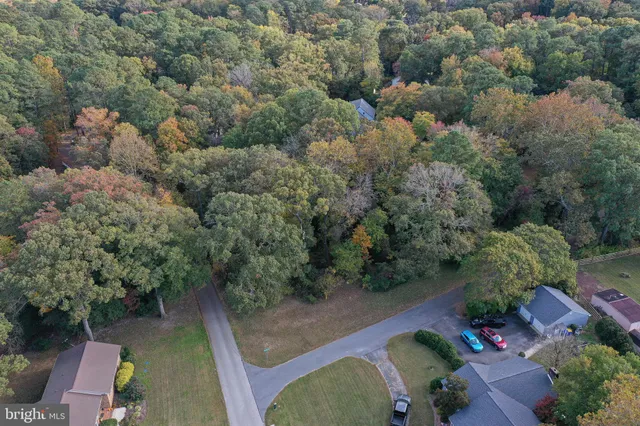 an aerial view of a house with yard swimming pool and lake view
