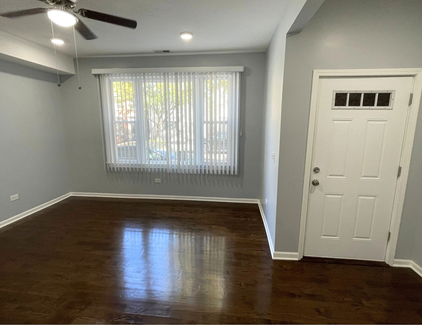 1836 South May Street, Unit 1 Chicago, IL 60608 - Photo 10 of 15 a view of an empty room with wooden floor and a window