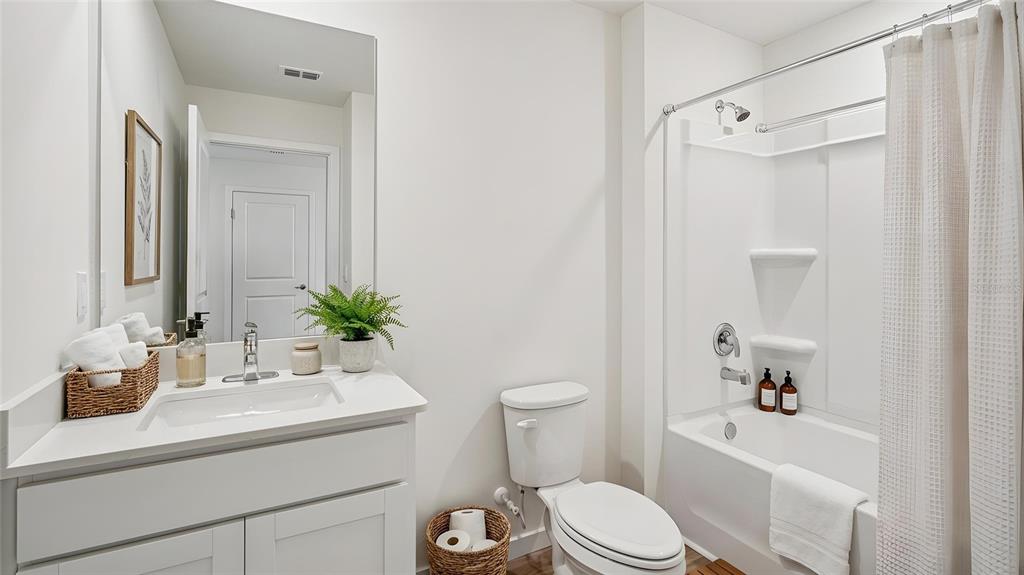 4023 Kona Circle Spring Hill, FL 34608 - Photo 8 of 18 a bathroom with a sink a toilet a tub and shower