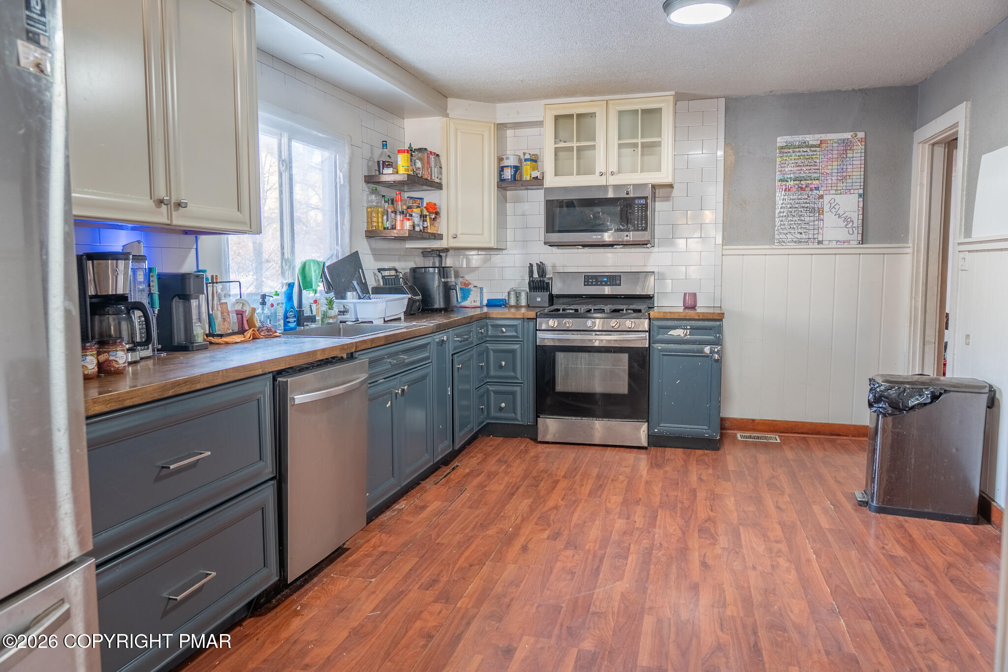 106 Independence Road East Stroudsburg, PA 18301 - Photo 11 of 30 a kitchen with stainless steel appliances granite countertop a stove top oven a sink dishwasher and a refrigerator with wooden floor