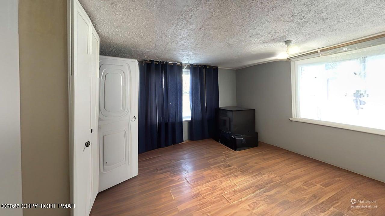106 Independence Road East Stroudsburg, PA 18301 - Photo 29 of 30 a view of an empty room with wooden floor and a window