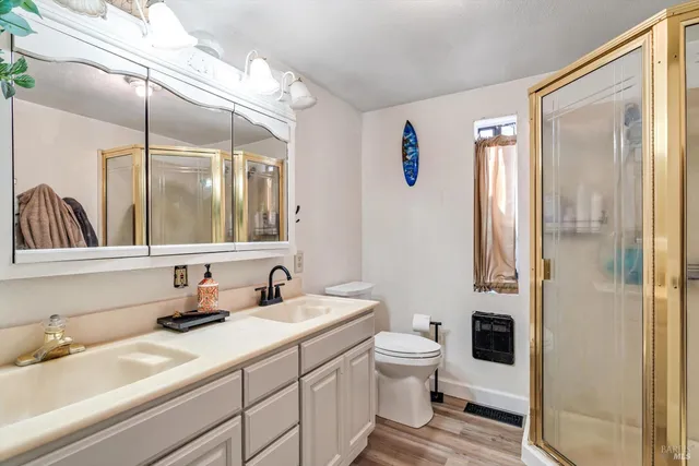 a bathroom with a toilet a sink and a mirror