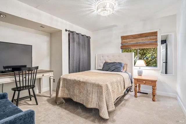 a bedroom with a bed chairs and a window