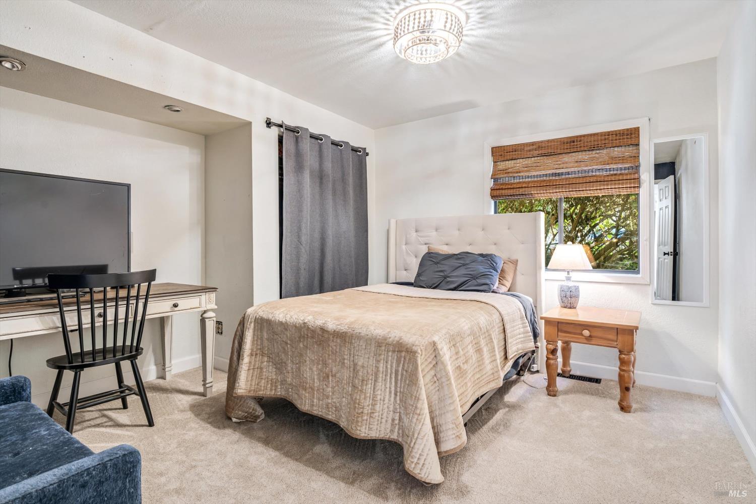 8061 Elphick Road Sebastopol, CA 95472 - Photo 13 of 40 a bedroom with a bed chairs and a window