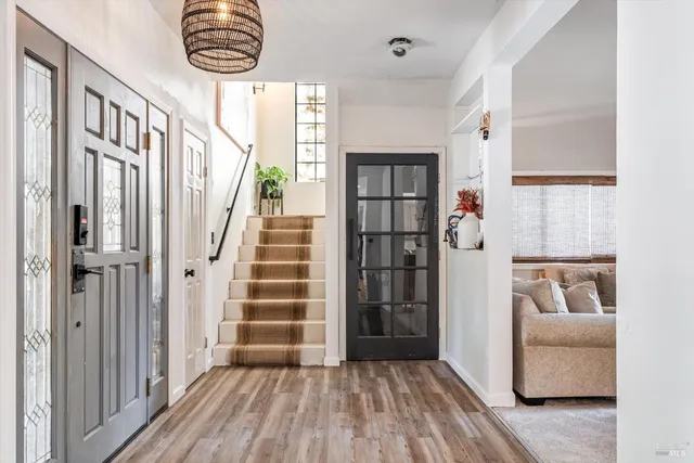 a view of entryway and hall with wooden floor