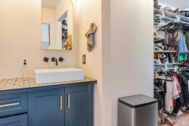 a bathroom with a granite countertop sink and a mirror