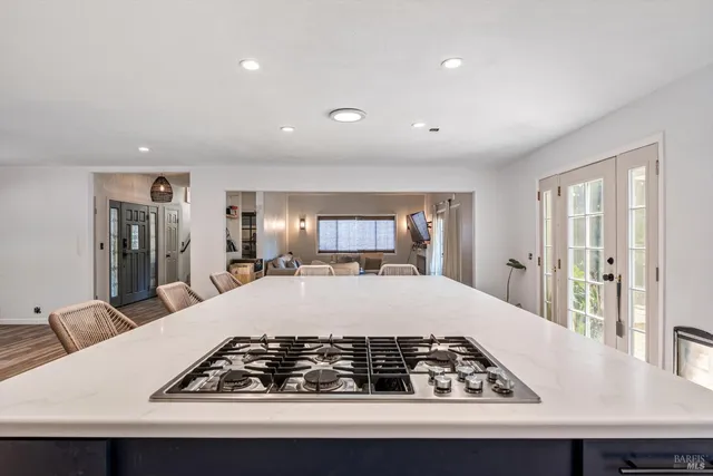 a room with a bed and a view of living room